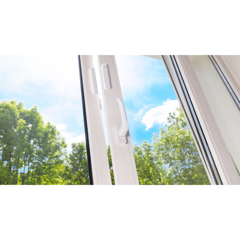 Ajax DoorProtect installed on white aluminium window frames