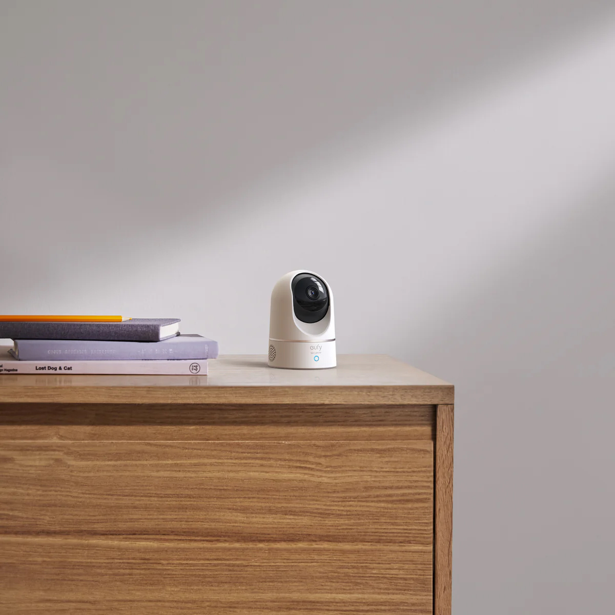 Eufy E220 Indoor Pan & Tilt Security Camera 2K placed on a wooden table